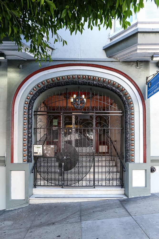 the front door of a building with a wrought iron gate