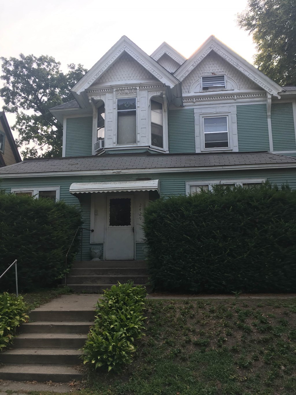 A blue house with a white door and windows.