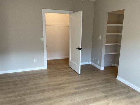 a living room with wood floors and a closet