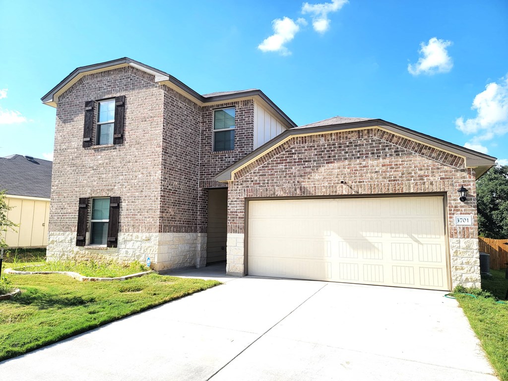 a house with a garage door in front of it