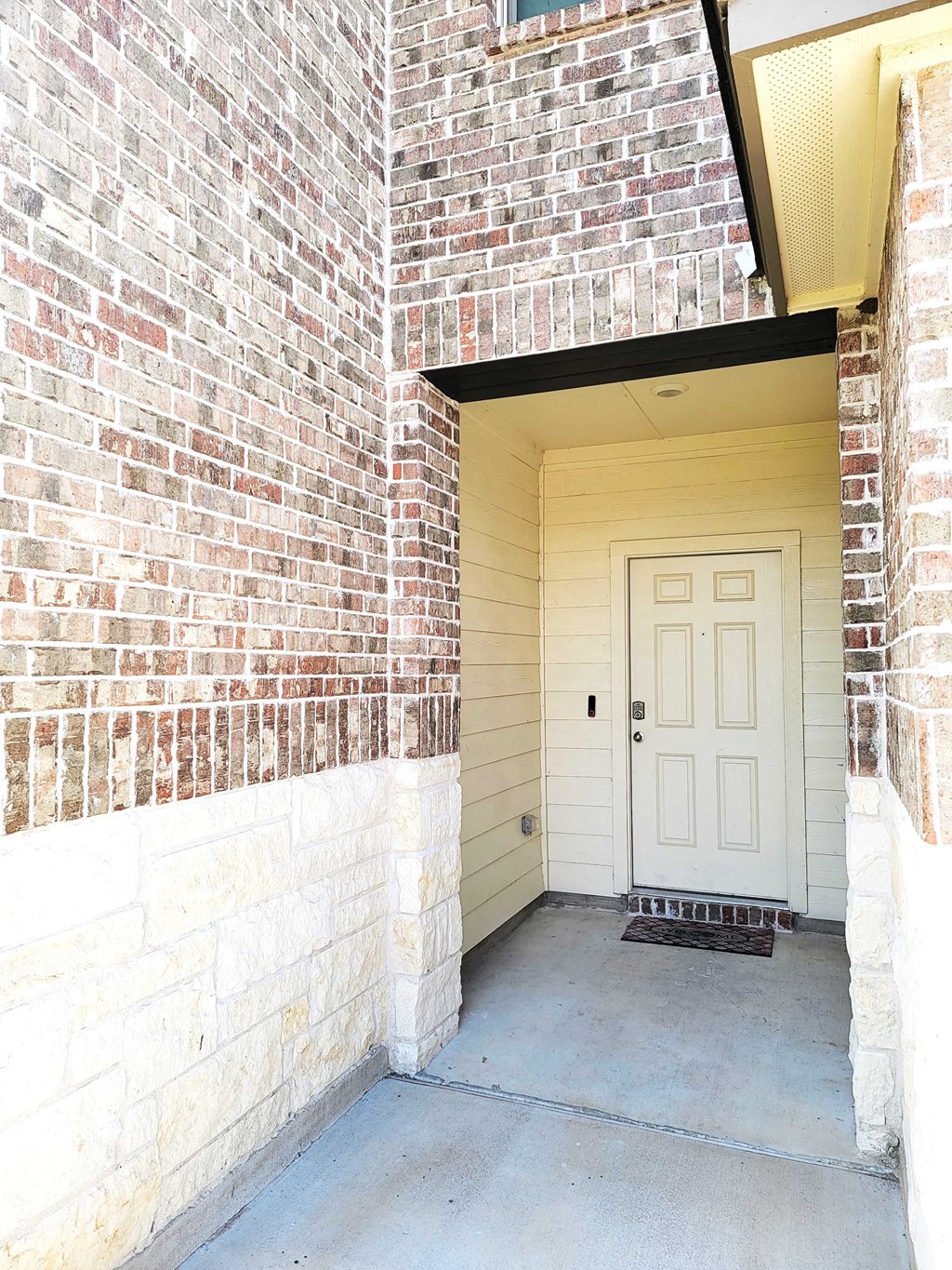 the front door of a brick building with a white door