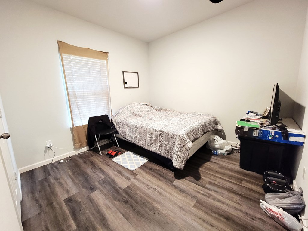 a small bedroom with a bed and a tv