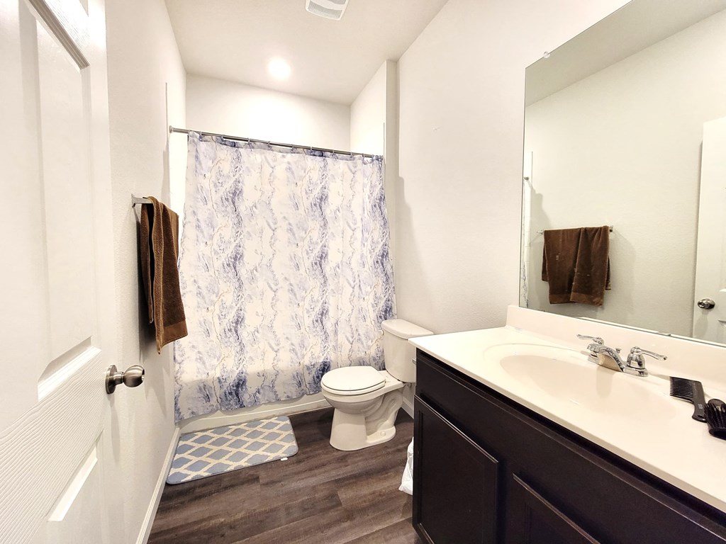 a bathroom with a shower toilet and sink