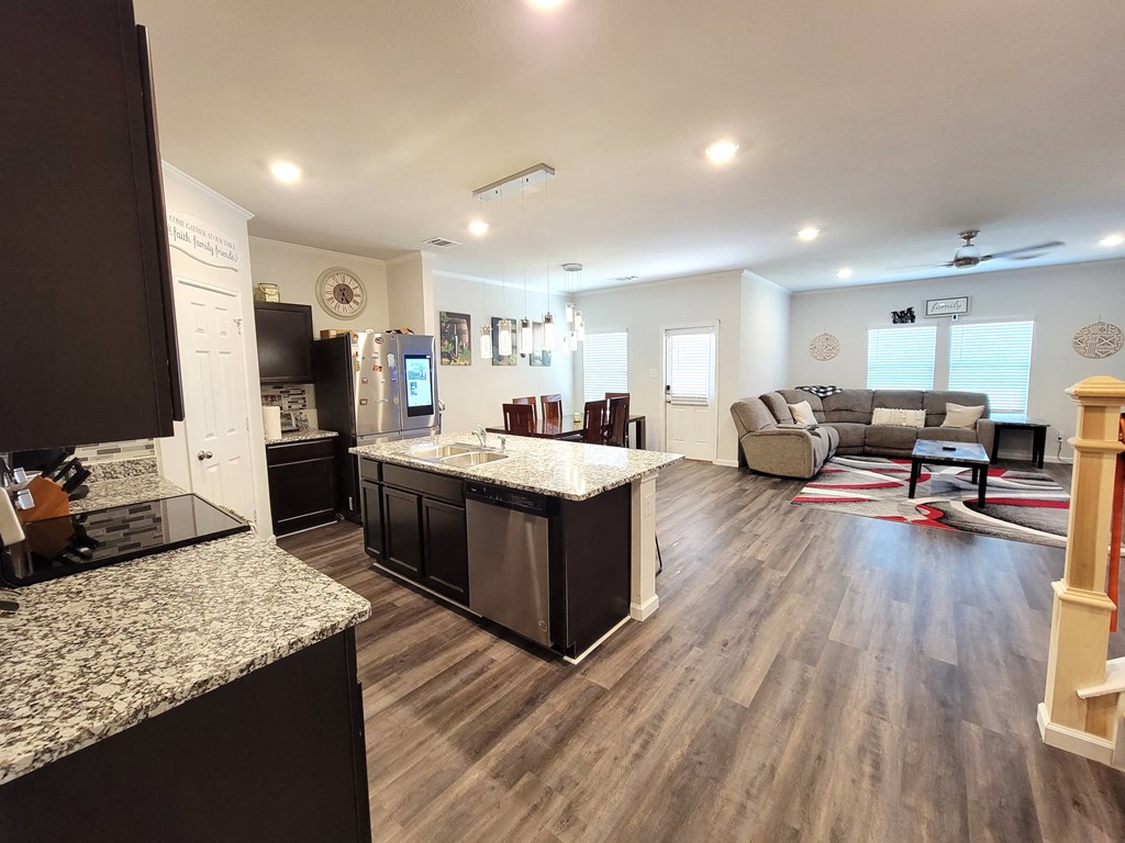 the view of the living room from the kitchen in a new home