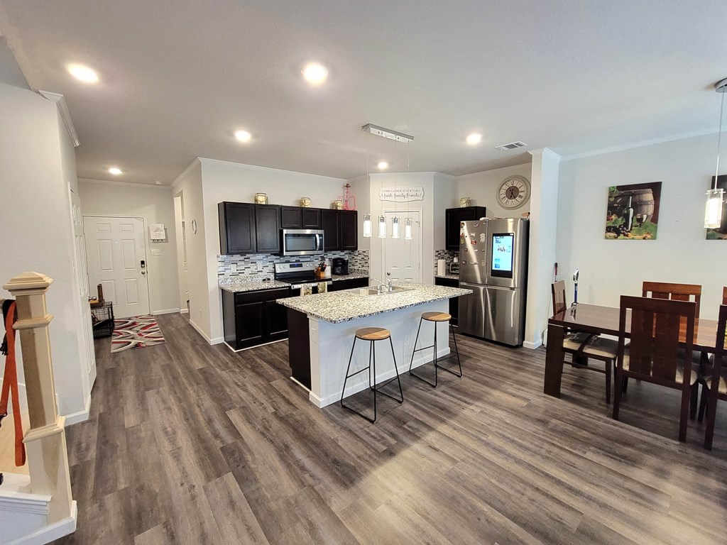 a kitchen with a bar and a counter top in a living room