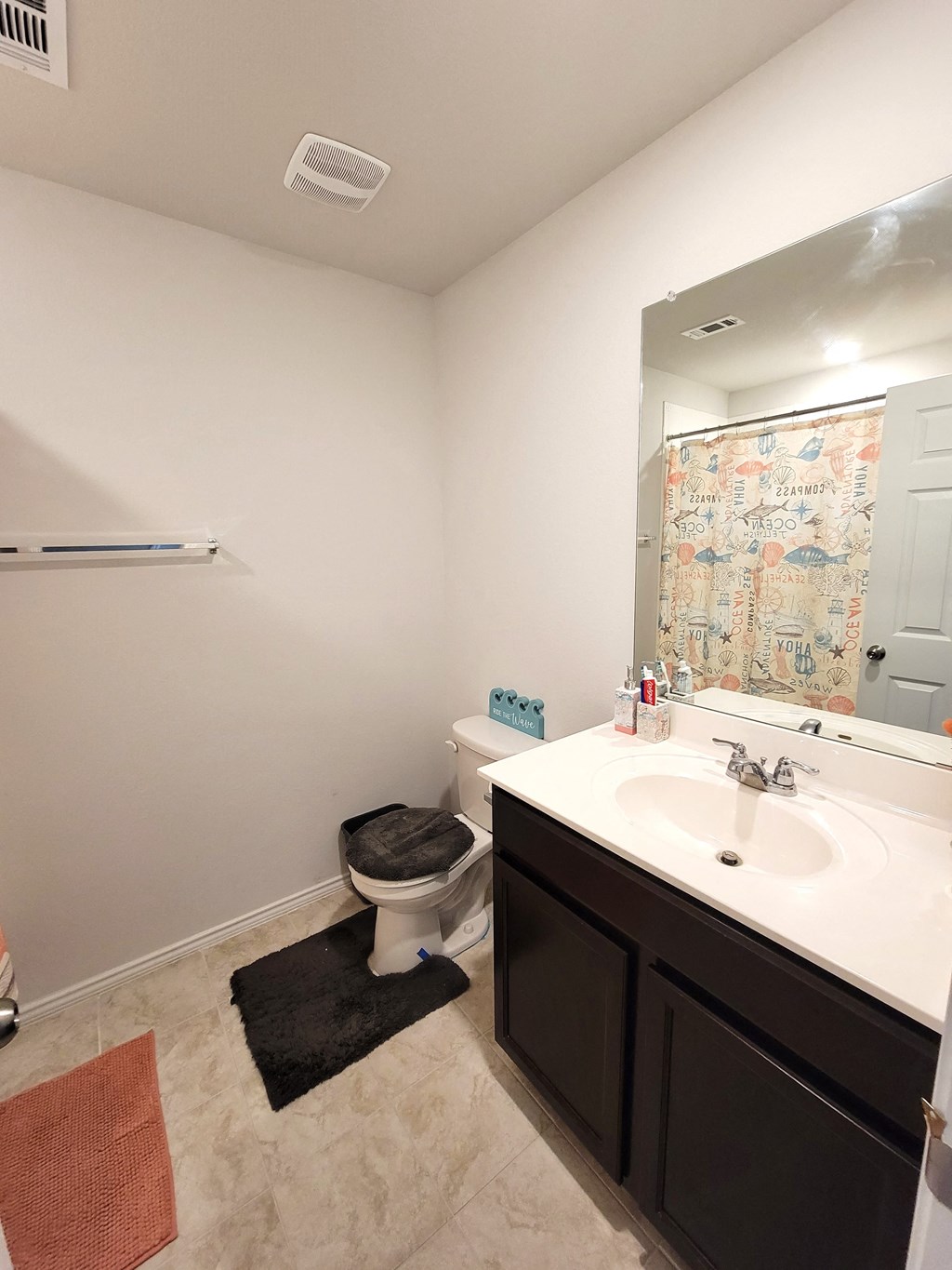 a bathroom with a sink and a toilet and a mirror