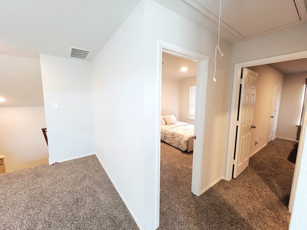 a bedroom with a closet and a hallway to a bedroom