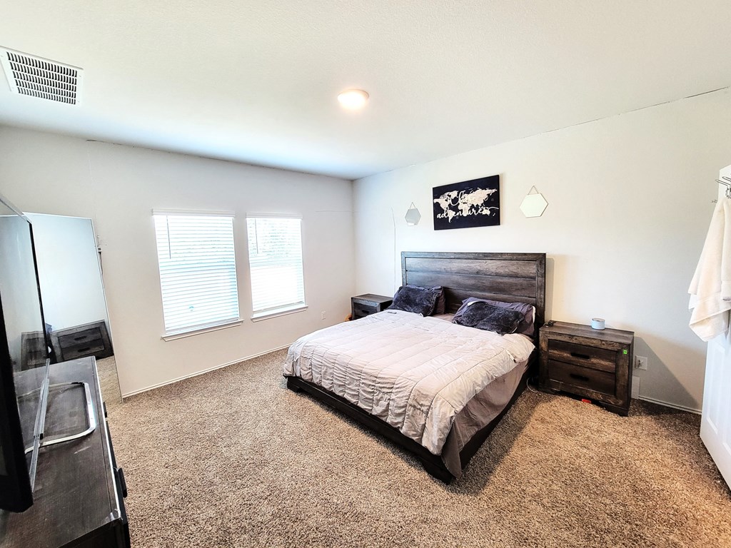 a bedroom with a bed and a window