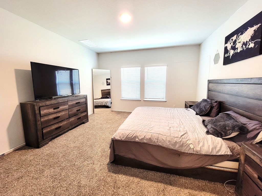 a bedroom with a bed and a tv
