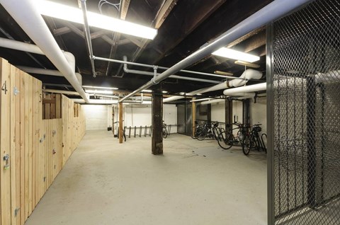 A spacious garage with wooden walls and a concrete floor.