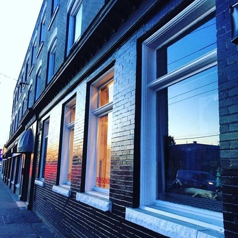 A building with windows and a sign that says "Ribson".