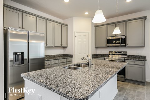 a kitchen with granite counter tops and stainless steel appliances