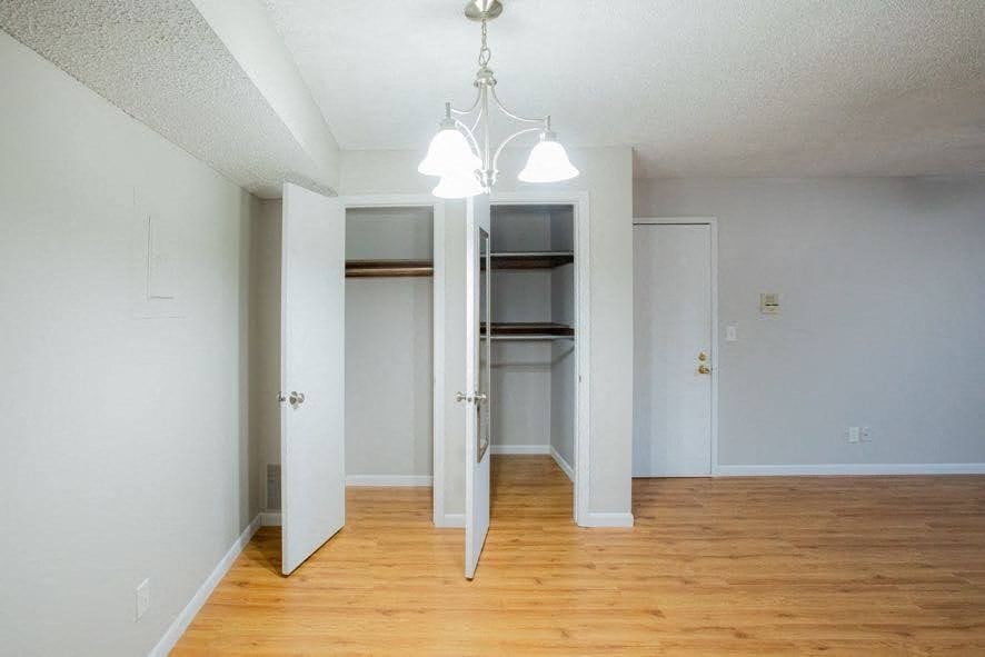 A room with a white wall and a wooden floor.