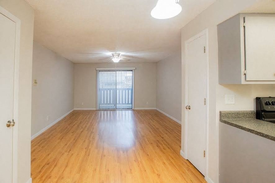 A room with wooden floors and white walls.