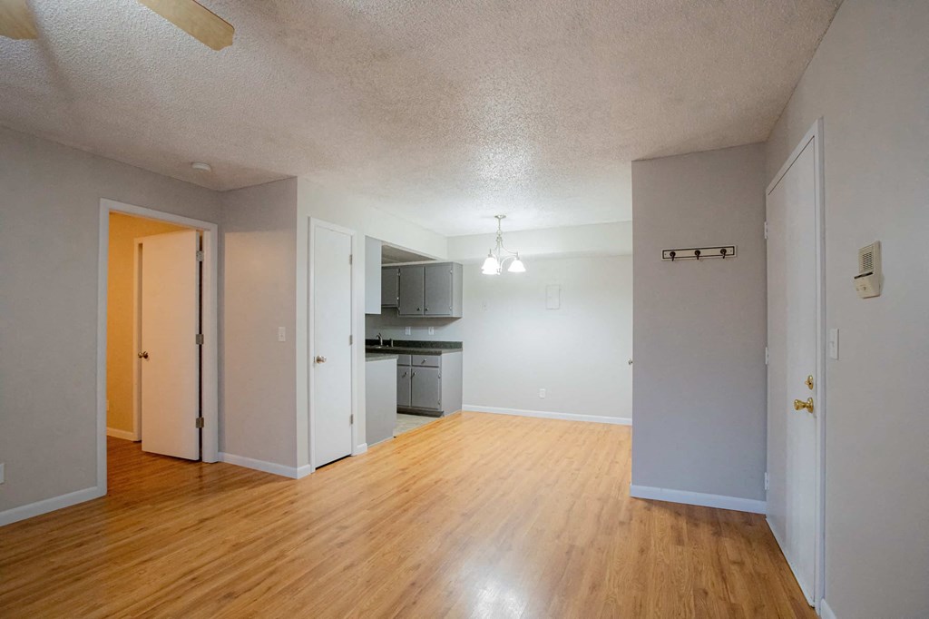 A kitchen area with a refrigerator, microwave, and oven.