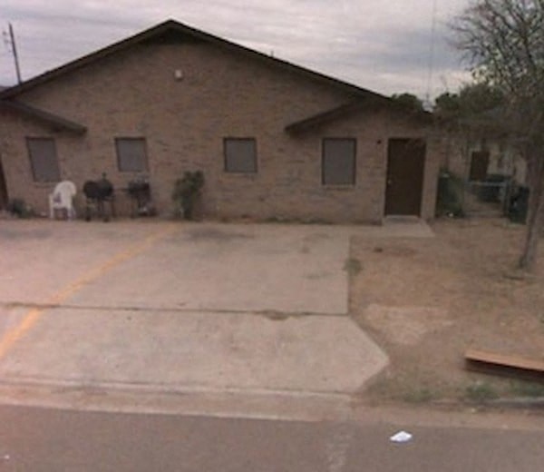 a house with a driveway and a horse in front of it
