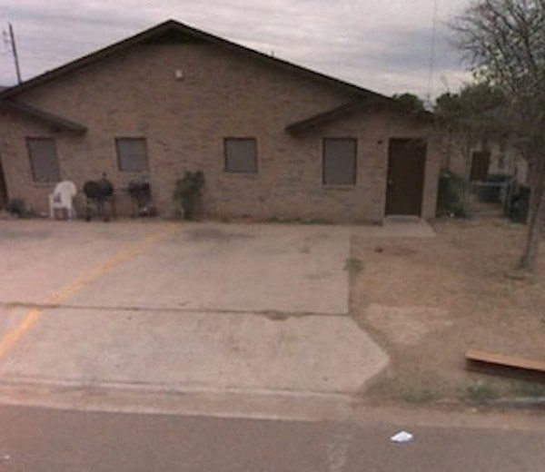 a brick house with a driveway in front of it