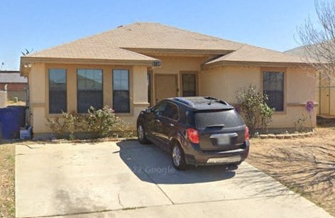 a car parked in a driveway in front of a house