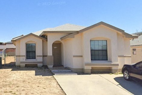 a house with a car parked outside of it