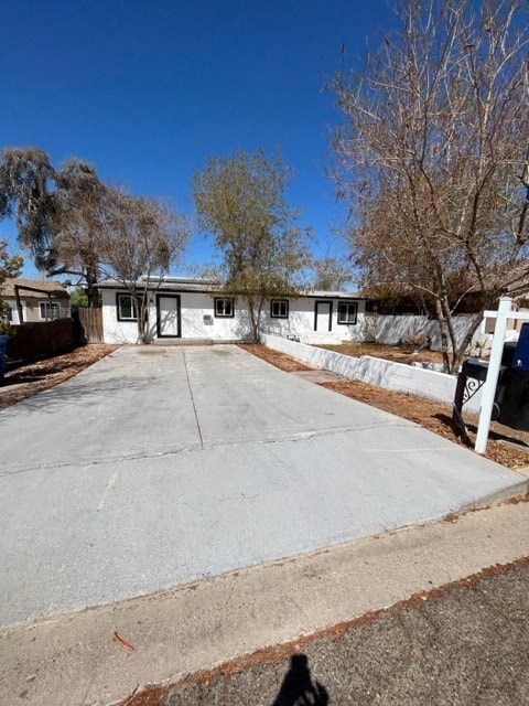 a white house with a driveway in front of it