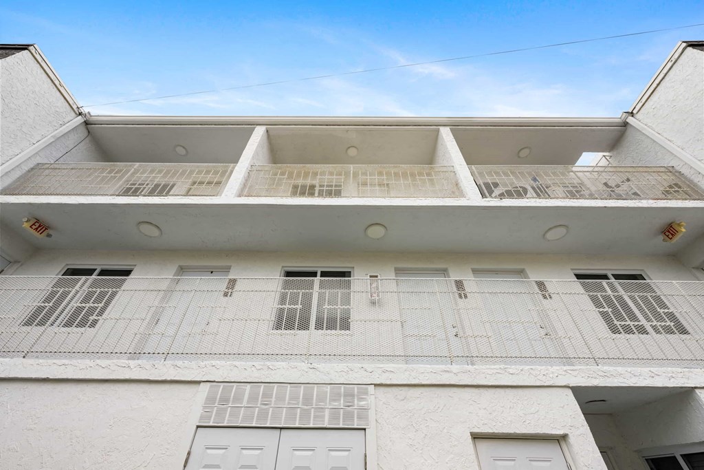 A white building with a flat roof and rectangular windows.