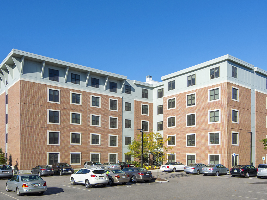 a large brick building with cars parked in a parking lot