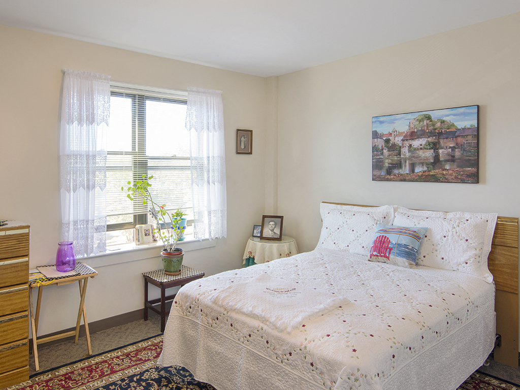 a bedroom with a bed and a window