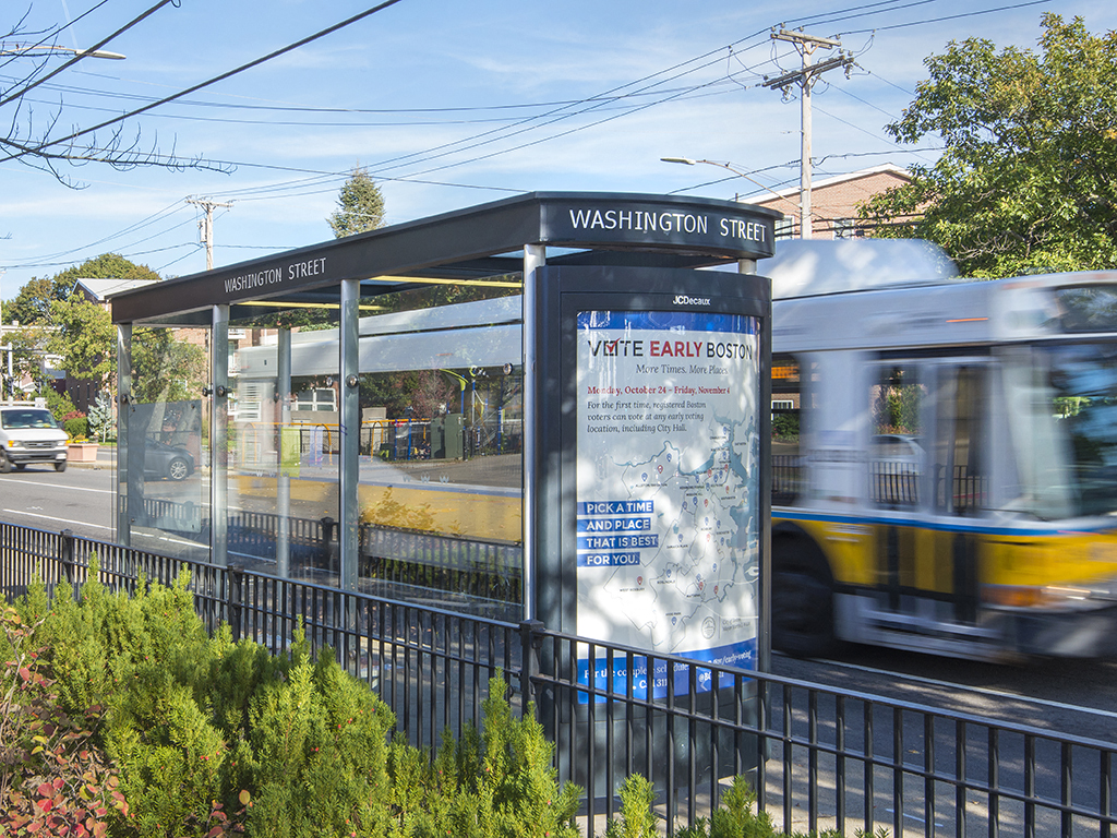 a bus stop with a bus on a city street
