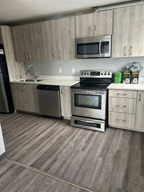 A kitchen with a stove top oven and microwave above it.