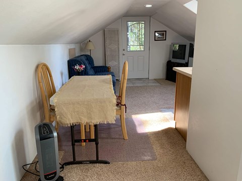 a dining room with a table and chairs in a small room
