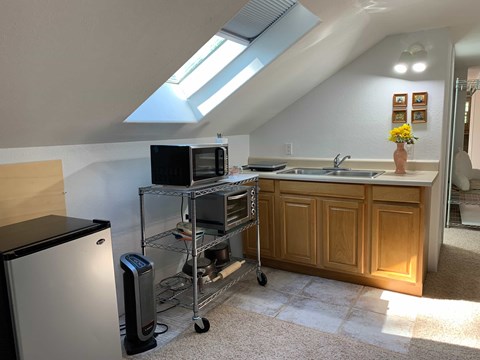 a kitchen or kitchenette with a microwave and a sink