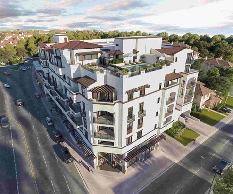 A modern multi-story building with balconies and a mix of white and darker exterior walls.