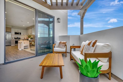 A modern living room with a wooden table and white couch.