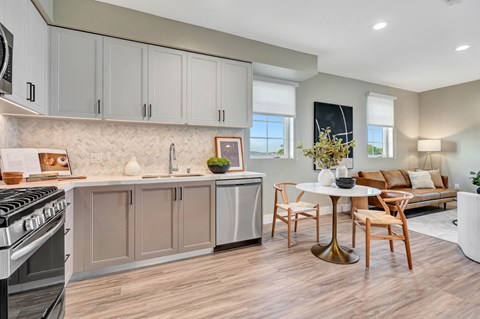A modern kitchen with a dining table and chairs.