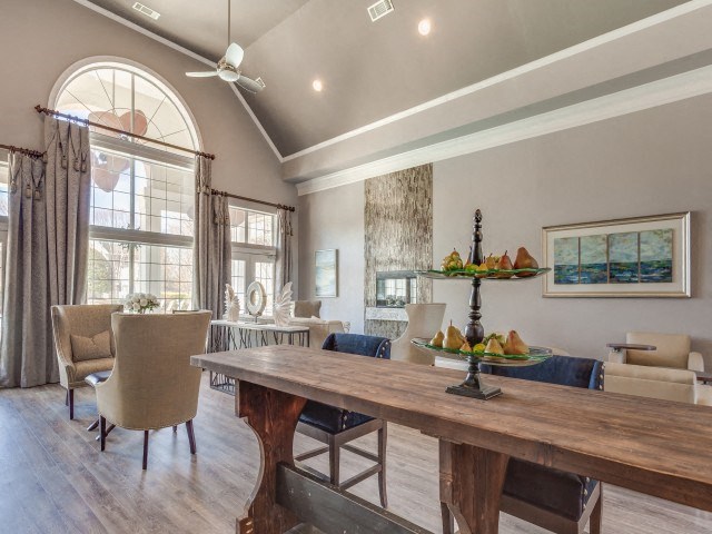 a dining room with a table and chairs and a large window