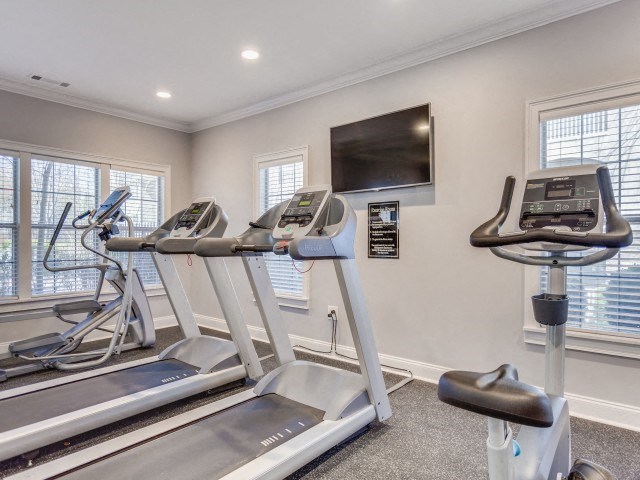 the gym has cardio equipment and a flat screen tv