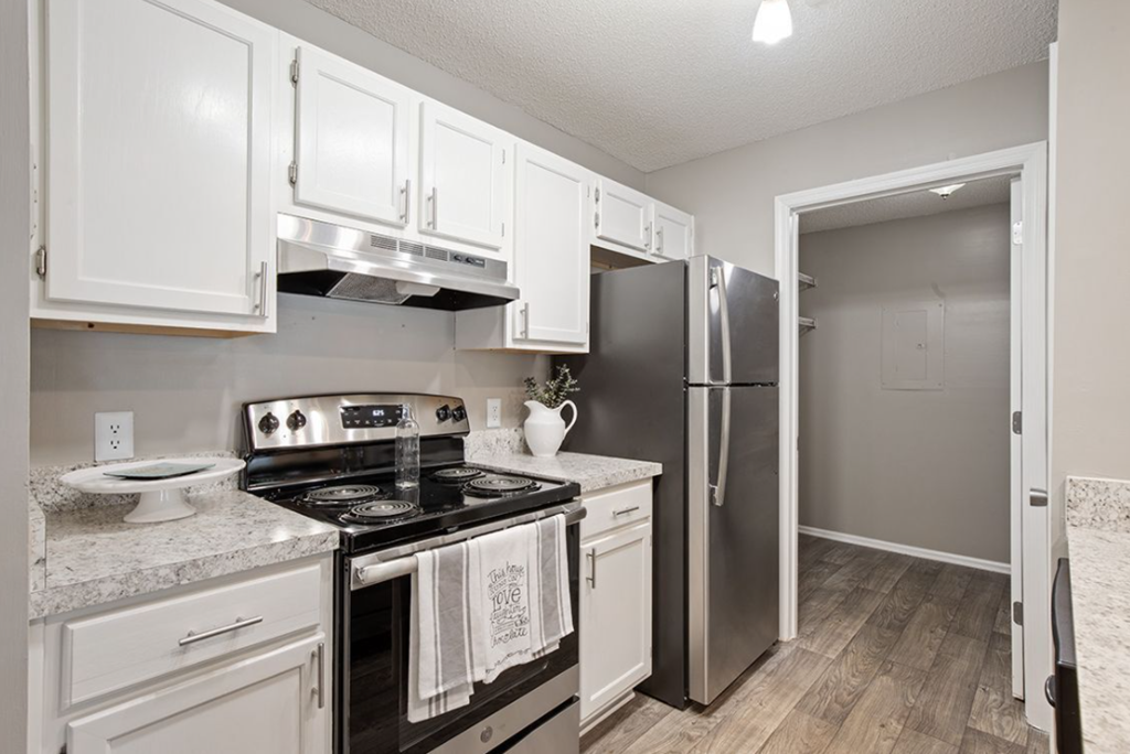 a kitchen with stainless steel appliances and white cabinets