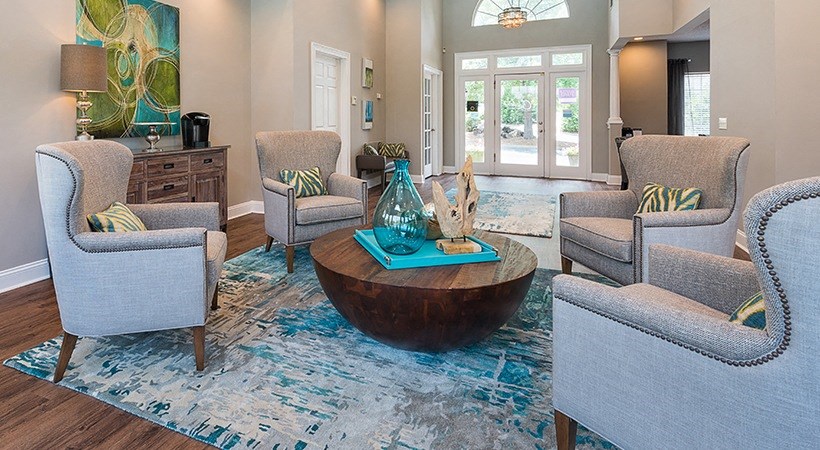 a living room with chairs and a table