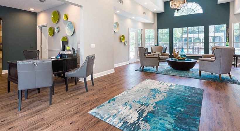 a living room with a dining room table and chairs