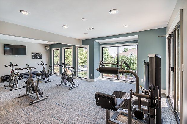 a gym with exercise equipment and a large window