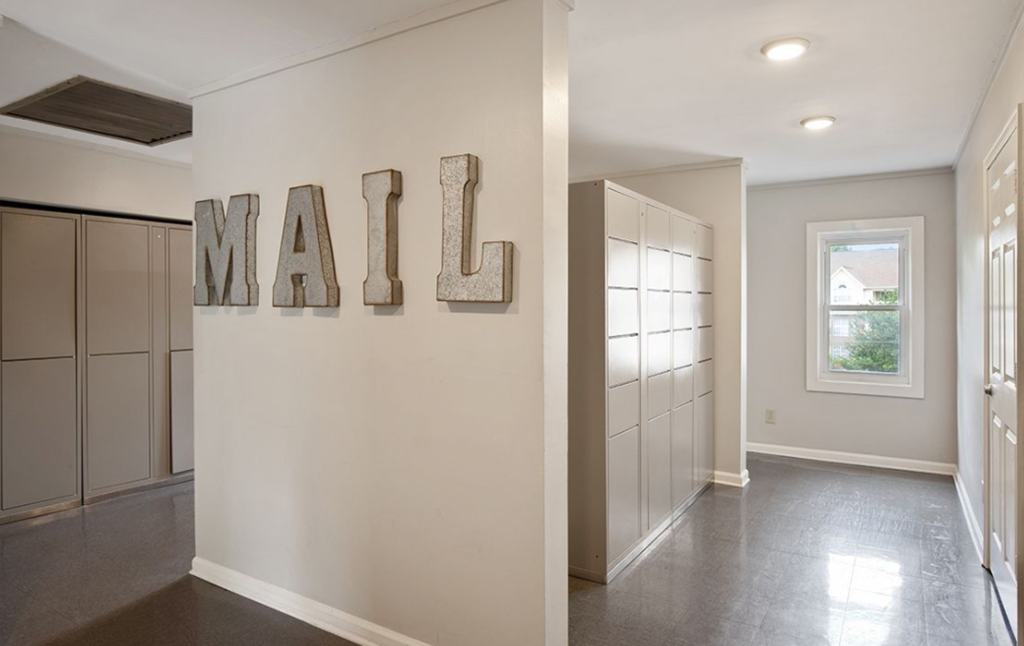 a hallway of a home with a mail sign on the wall
