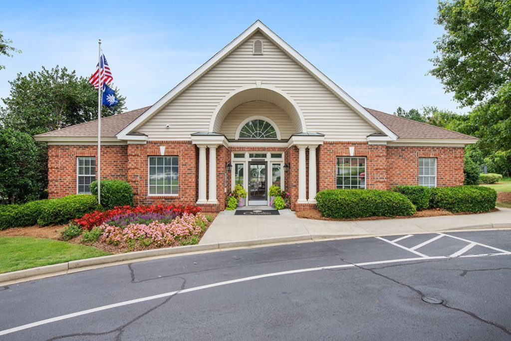 the front of a brick building with an flag on the side of it
