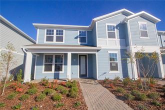 a blue house with a walkway in front of it