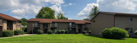 Apartment complex with a green lawn in front.