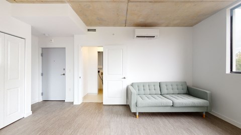 a living room with white walls and a couch