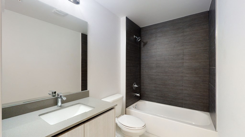 a bathroom with a sink toilet and bath tub