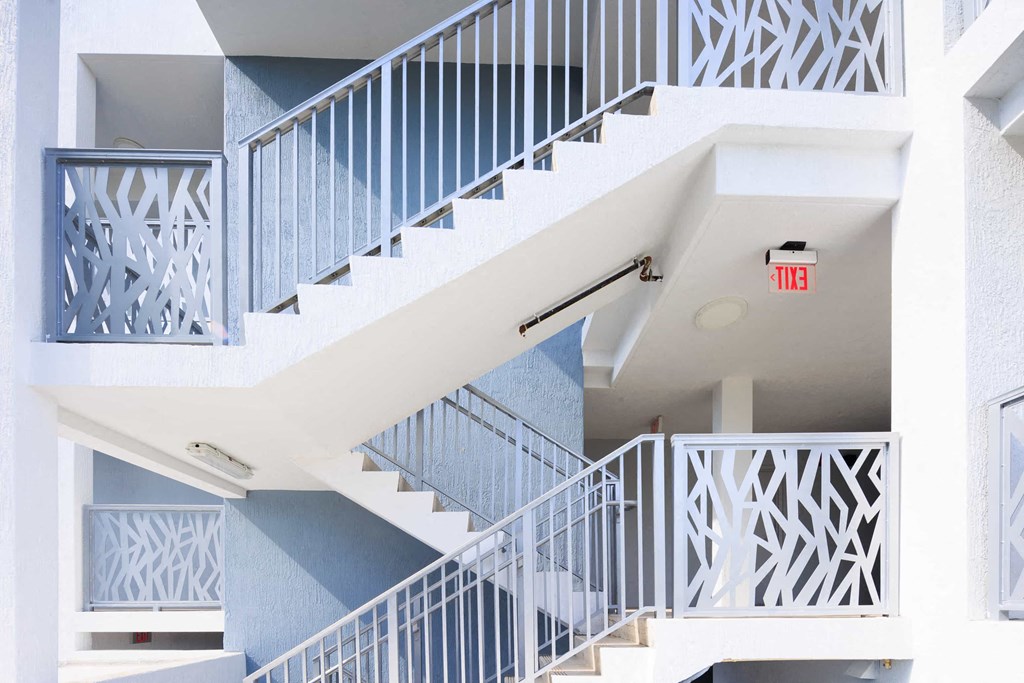 a white and blue staircase in a building