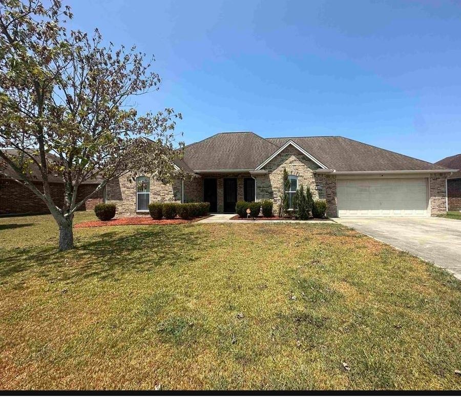 a house with a lawn and a tree
