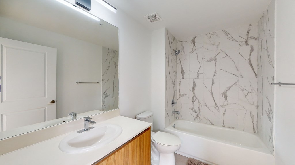 a bathroom with a sink toilet and a bath tub