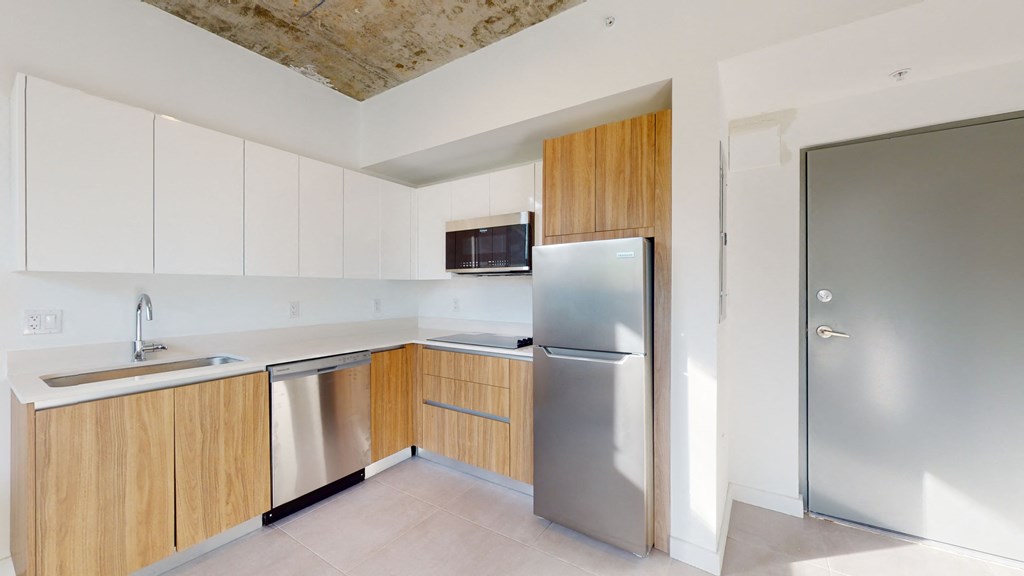 a modern kitchen with stainless steel appliances and wooden cabinets